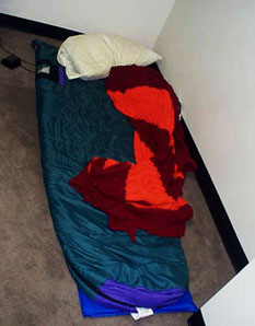 A disorderly sleeping bag in a corner